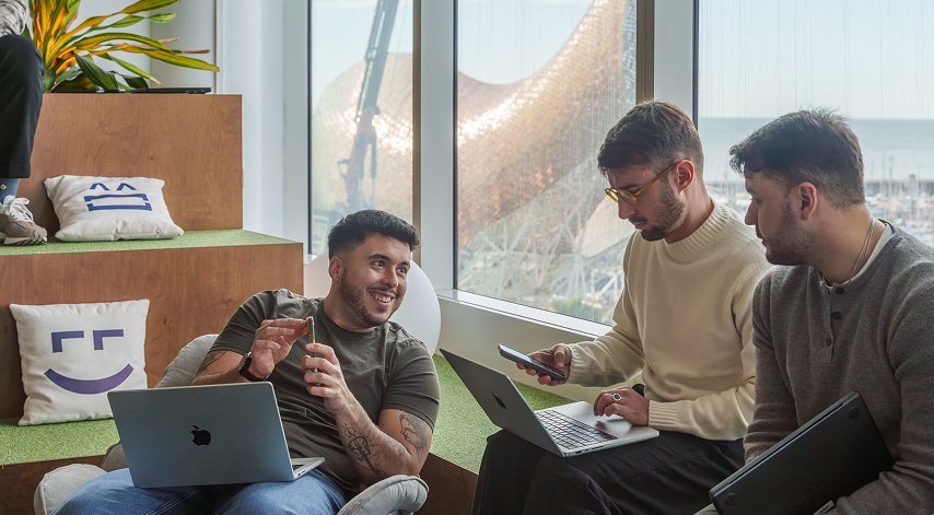 Leadtech colleagues collaborating at a laptop in Barcelona